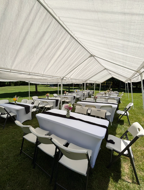 Full tent setup with tables and chairs for a large gathering